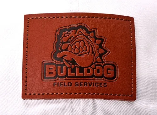 Debossed leather patch reading Bulldog Field Services