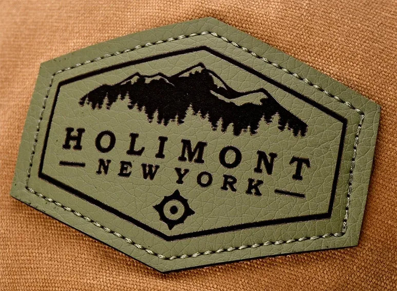 Etched leather patch reading Holimont New York