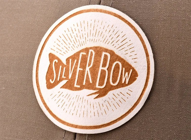 Laser-etched leather patch on a camo cap