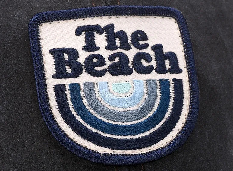 Embroidered patch with mountain artwork on a cap
