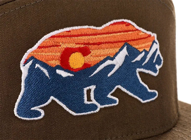 Direct embroidery: bear and mountain sunset design stitched on a brown cap