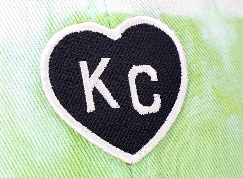 Heart-shaped embroidered patch reading KC
