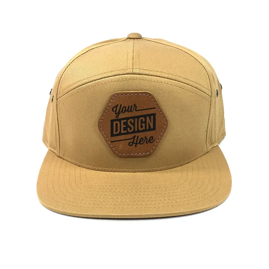 Tan seven-panel hat with a laser-etched leather patch