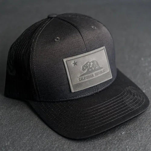 Black trucker hat with a debossed leather California Republic patch